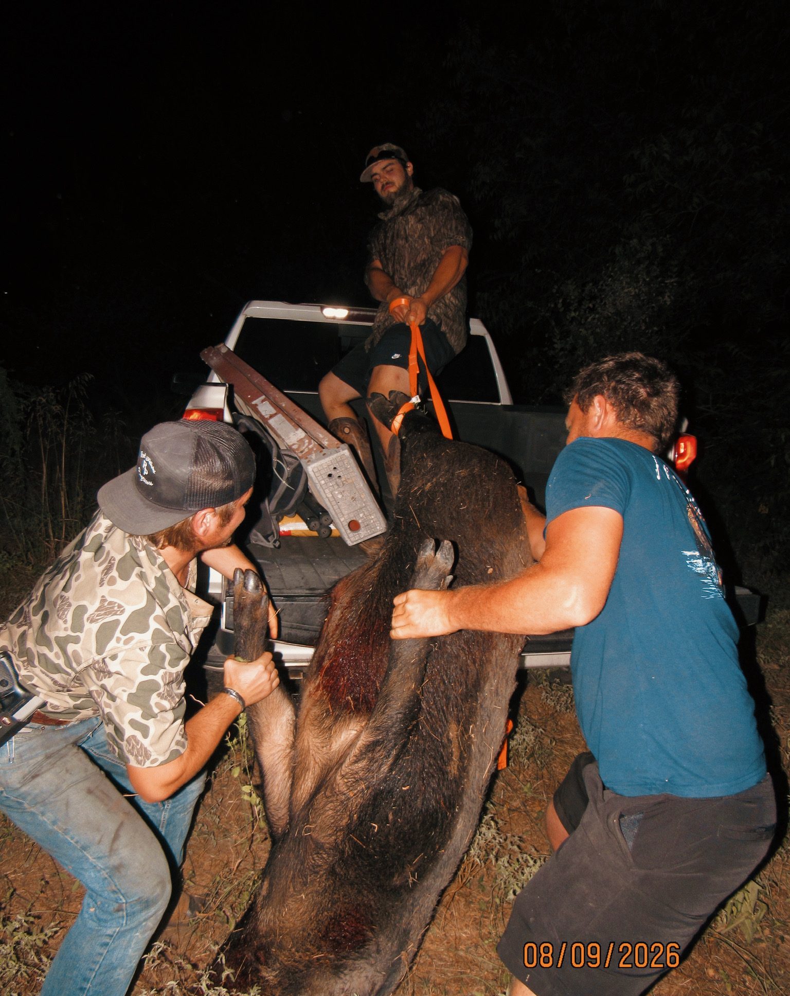 Loading up a boar after a Mesa Valley Outdoors night hog hunt